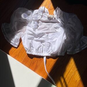 White cropped top with crunchy sleeves. Fits size Small.